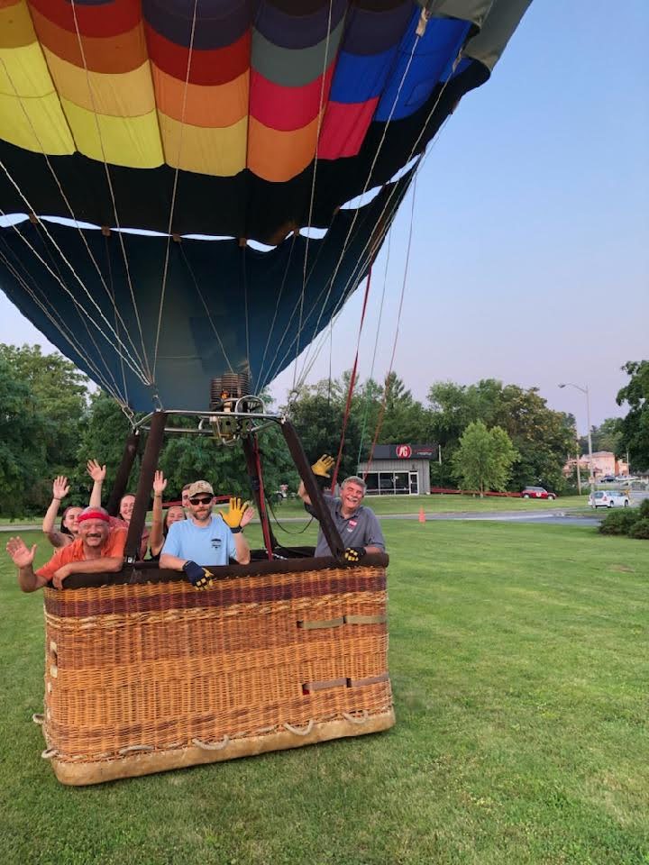photo of a hot air balloon with guests in the basket